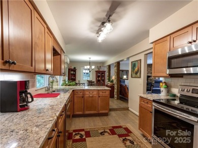 This contemporary mountain home situated on a private wooded lot on Mt. Mitchell Golf Course in North Carolina - for sale on GolfHomes.com, golf home, golf lot