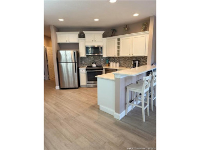 This exquisite first-floor condominium boasts unobstructed views on The Legacy Golf and Tennis Club in Florida - for sale on GolfHomes.com, golf home, golf lot