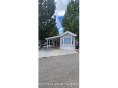 Completely updated park model with a spacious bonus room located on Star Valley RV Golf Course in Wyoming - for sale on GolfHomes.com, golf home, golf lot