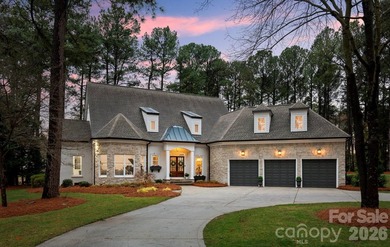 Set on a level one-acre lot on the 5th hole of Trump National on Trump National Golf Club Charlotte in North Carolina - for sale on GolfHomes.com, golf home, golf lot