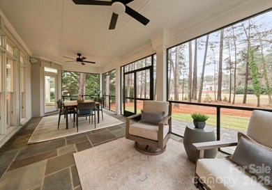 Set on a level one-acre lot on the 5th hole of Trump National on Trump National Golf Club Charlotte in North Carolina - for sale on GolfHomes.com, golf home, golf lot