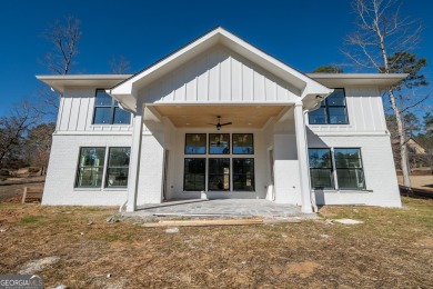 This gorgeous new construction is directly on Osprey Pointe Pond on Harbor Club Golf and Country Club in Georgia - for sale on GolfHomes.com, golf home, golf lot