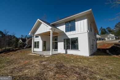 This gorgeous new construction is directly on Osprey Pointe Pond on Harbor Club Golf and Country Club in Georgia - for sale on GolfHomes.com, golf home, golf lot