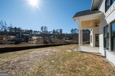 This gorgeous new construction is directly on Osprey Pointe Pond on Harbor Club Golf and Country Club in Georgia - for sale on GolfHomes.com, golf home, golf lot