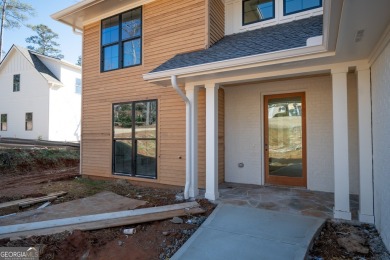 This gorgeous new construction is directly on Osprey Pointe Pond on Harbor Club Golf and Country Club in Georgia - for sale on GolfHomes.com, golf home, golf lot