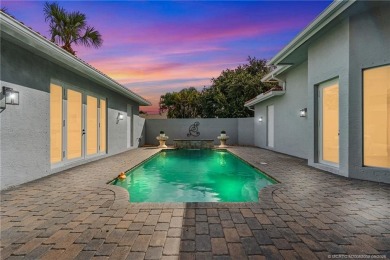 Welcome to your own private sanctuary-an elegant courtyard pool on The Cape Club of Palm City in Florida - for sale on GolfHomes.com, golf home, golf lot