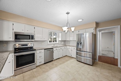 Welcome home to this 3-bedroom, 2-bath residence in the on River Bend Golf and Country Club in North Carolina - for sale on GolfHomes.com, golf home, golf lot