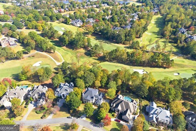COMMANDING MASSIVE PALATIAL COLUMNS, THIS SUGARLOAF COUNTRY CLUB on TPC At Sugarloaf Golf Club in Georgia - for sale on GolfHomes.com, golf home, golf lot