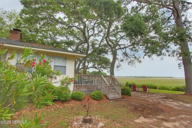 Embark on a journey to this magnificent 3 bedroom 2 bath home on Oyster Bay Golf Links in North Carolina - for sale on GolfHomes.com, golf home, golf lot