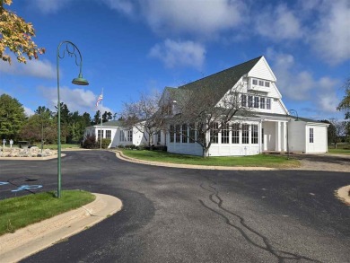 Experience elegance and functionality in this stunning on Charlevoix Golf and Country Club in Michigan - for sale on GolfHomes.com, golf home, golf lot