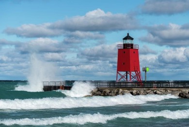 Experience elegance and functionality in this stunning on Charlevoix Golf and Country Club in Michigan - for sale on GolfHomes.com, golf home, golf lot