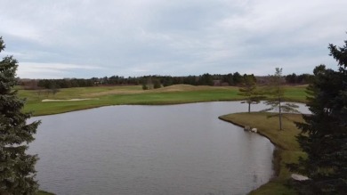 Experience elegance and functionality in this stunning on Charlevoix Golf and Country Club in Michigan - for sale on GolfHomes.com, golf home, golf lot