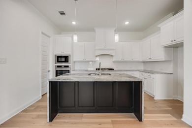 This highly sought-after single-story Altura Aspen floorplan is on Heath Golf and Yacht Club in Texas - for sale on GolfHomes.com, golf home, golf lot