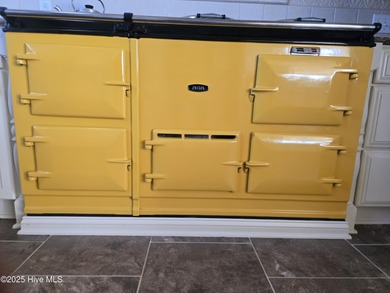 This elegant ranch-style residence offers panoramic views of on Ocean Ridge Plantation in North Carolina - for sale on GolfHomes.com, golf home, golf lot