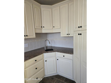 This elegant ranch-style residence offers panoramic views of on Ocean Ridge Plantation in North Carolina - for sale on GolfHomes.com, golf home, golf lot