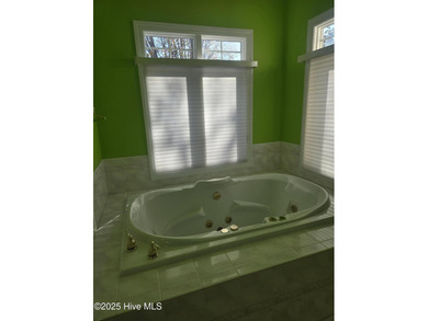 This elegant ranch-style residence offers panoramic views of on Ocean Ridge Plantation in North Carolina - for sale on GolfHomes.com, golf home, golf lot