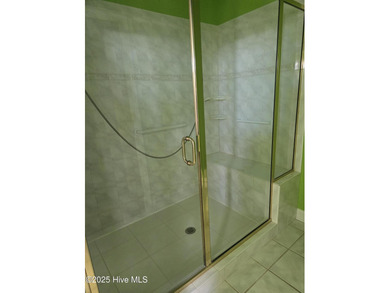 This elegant ranch-style residence offers panoramic views of on Ocean Ridge Plantation in North Carolina - for sale on GolfHomes.com, golf home, golf lot