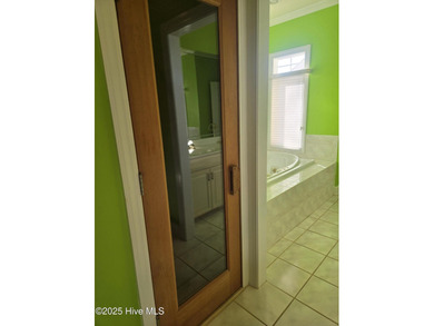 This elegant ranch-style residence offers panoramic views of on Ocean Ridge Plantation in North Carolina - for sale on GolfHomes.com, golf home, golf lot