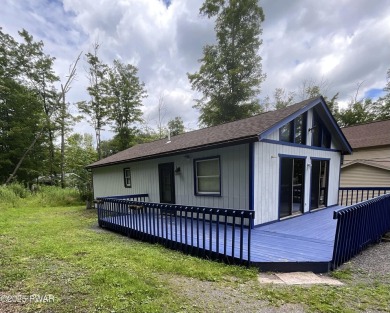 Fall in love with this sweet, simple, and affordable getaway in on The Hideout Golf in Pennsylvania - for sale on GolfHomes.com, golf home, golf lot