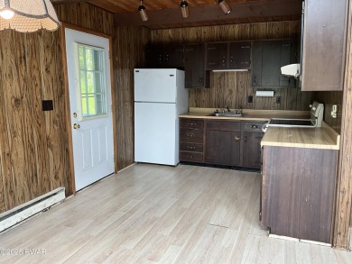 Fall in love with this sweet, simple, and affordable getaway in on The Hideout Golf in Pennsylvania - for sale on GolfHomes.com, golf home, golf lot
