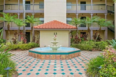 Experience serene pond views from this first-floor, corner unit on Feather Sound Country Club in Florida - for sale on GolfHomes.com, golf home, golf lot