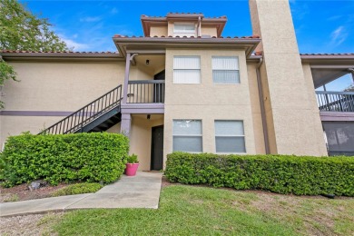 Experience serene pond views from this first-floor, corner unit on Feather Sound Country Club in Florida - for sale on GolfHomes.com, golf home, golf lot