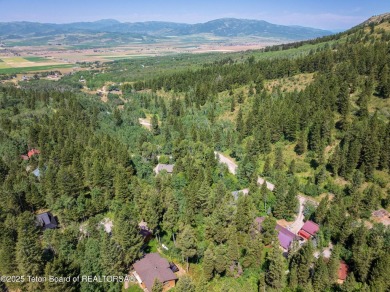 Tucked into the trees on a quiet street in Star Valley Ranch on Star Valley RV Golf Course in Wyoming - for sale on GolfHomes.com, golf home, golf lot