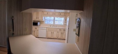 This lovely 1982 mobile home comes unfurnished and is poised and on Royal Wood Golf and Country Club in Florida - for sale on GolfHomes.com, golf home, golf lot