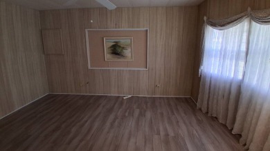 This lovely 1982 mobile home comes unfurnished and is poised and on Royal Wood Golf and Country Club in Florida - for sale on GolfHomes.com, golf home, golf lot
