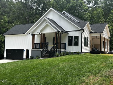 Welcome to 101 Cochise Cove, a 3-bedroom, 3.5-bath home with 3 on River Golf and County Club at Lake Royale in North Carolina - for sale on GolfHomes.com, golf home, golf lot