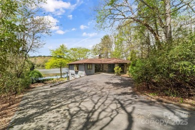 LAKEFRONT LIVING AS IT'S FINEST! Nestled in serene natural on Connestee Falls Golf Club in North Carolina - for sale on GolfHomes.com, golf home, golf lot
