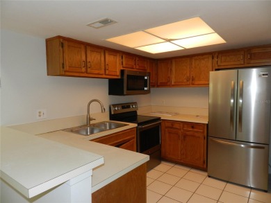 Freshly painted 2 bedroom, 2 bath ground floor end unit with1 on Innisbrook Resort and Golf Club in Florida - for sale on GolfHomes.com, golf home, golf lot