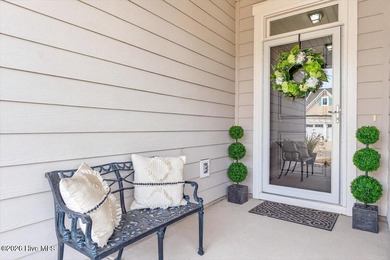 The welcoming front porch sets the tone for this beautiful home on Members Club At St. James Plantation in North Carolina - for sale on GolfHomes.com, golf home, golf lot