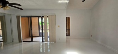 Lovely townhome. It features fresh paint, new porcelain tile on on Woodmont Country Club in Florida - for sale on GolfHomes.com, golf home, golf lot