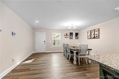 Built in 2024 and thoughtfully enhanced beyond the builder's on Carolina Trace Country Club in North Carolina - for sale on GolfHomes.com, golf home, golf lot