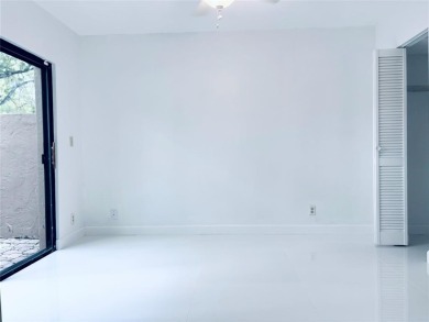 Lovely townhome. It features fresh paint, new porcelain tile on on Woodmont Country Club in Florida - for sale on GolfHomes.com, golf home, golf lot