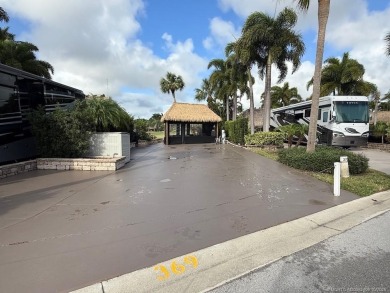 This beautifully landscaped tiki lot offers breathtaking sunset on Motorcoach Resort Golf Course in Florida - for sale on GolfHomes.com, golf home, golf lot