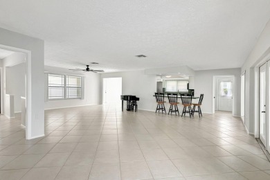 Panoramic golf and lake views abound at this Sandpiper Bay gem! on The Saints At Port St Lucie Golf Course in Florida - for sale on GolfHomes.com, golf home, golf lot