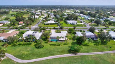 Panoramic golf and lake views abound at this Sandpiper Bay gem! on The Saints At Port St Lucie Golf Course in Florida - for sale on GolfHomes.com, golf home, golf lot