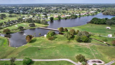 Panoramic golf and lake views abound at this Sandpiper Bay gem! on The Saints At Port St Lucie Golf Course in Florida - for sale on GolfHomes.com, golf home, golf lot