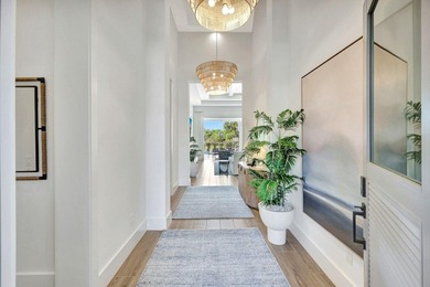 This stunning single-story residence, built in 2023, showcases on The Golf Club At Fiddlers Creek in Florida - for sale on GolfHomes.com, golf home, golf lot