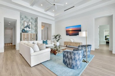 This stunning single-story residence, built in 2023, showcases on The Golf Club At Fiddlers Creek in Florida - for sale on GolfHomes.com, golf home, golf lot