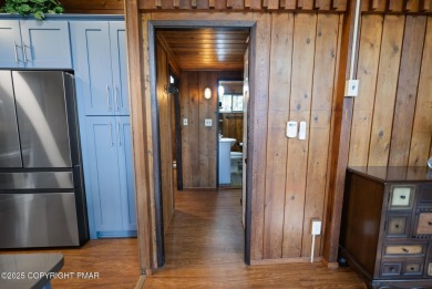 Let the outside in with this beautiful original Lake Naomi cabin on Lake Naomi Timber Trails Golf Club in Pennsylvania - for sale on GolfHomes.com, golf home, golf lot