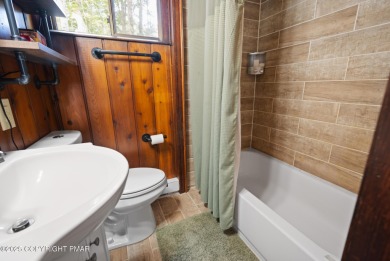 Let the outside in with this beautiful original Lake Naomi cabin on Lake Naomi Timber Trails Golf Club in Pennsylvania - for sale on GolfHomes.com, golf home, golf lot