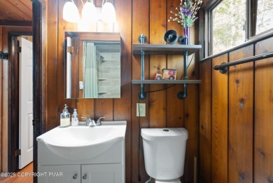 Let the outside in with this beautiful original Lake Naomi cabin on Lake Naomi Timber Trails Golf Club in Pennsylvania - for sale on GolfHomes.com, golf home, golf lot