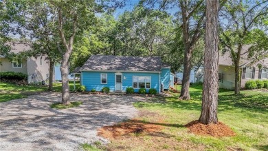 This quaint and charming lakefront bungalow offers a peaceful on Linn Valley Lakes - Deer Trace Golf Course in Kansas - for sale on GolfHomes.com, golf home, golf lot