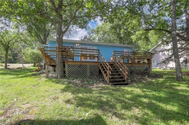 This quaint and charming lakefront bungalow offers a peaceful on Linn Valley Lakes - Deer Trace Golf Course in Kansas - for sale on GolfHomes.com, golf home, golf lot