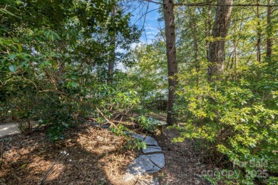Access this beautifully remodeled Wright-inspired midcentury on Tryon Country Club in North Carolina - for sale on GolfHomes.com, golf home, golf lot