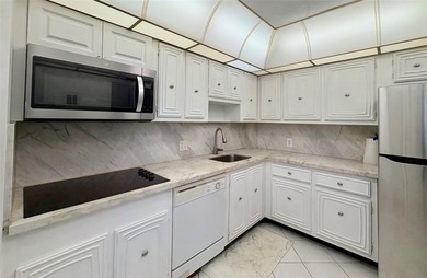 Experience spacious living in this 1BR/1.5BA condo in Palm Aire on Palm-Aire Country Club and Resort - Palms in Florida - for sale on GolfHomes.com, golf home, golf lot