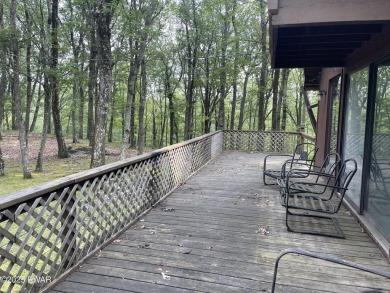 Tucked at the end of a quiet cul-de-sac and overlooking a on Paupack Hills Golf and Country Club in Pennsylvania - for sale on GolfHomes.com, golf home, golf lot
